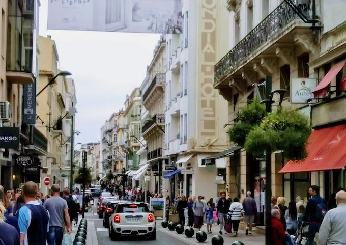 Rue d'Antibes está llena de gente y boutiques.