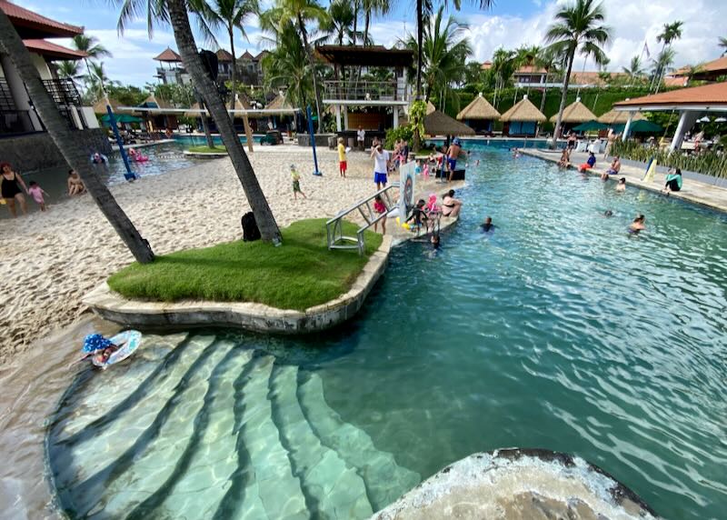 Children play in the long pool at the Hard Rock Hotel Bali in Kuta.